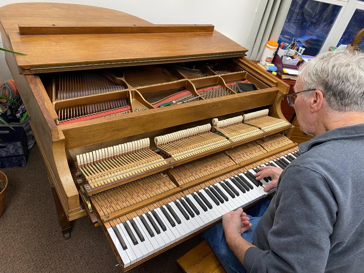 Piano technician tuning piano in Hudson Valley